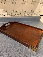 Top view of wooden tray showing smooth flat surface and metal corner protectors