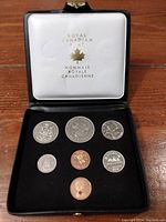 Original black presentation case with six Canadian coins neatly displayed. Case lid embossed with Royal Canadian Mint and maple leaf.