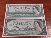 Front view of 1954 and 1967 Canadian $1 bills showing portrait of Queen Elizabeth II