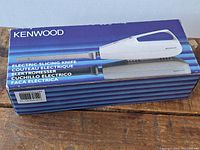 Box of Kenwood electric slicing knife showing product image, brand name, and multilingual labelling of the product as electric slicing knife.