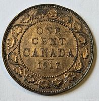 Reverse side showing denomination ONE CENT CANADA 1917 surrounded by maple leaf wreath.