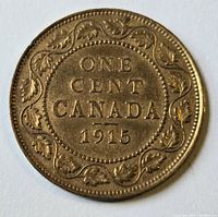 Reverse side of 1915 Canadian penny with denomination and maple leaf wreath design.