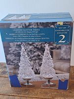 Box front showing set of two lighted glitter trees with color changing LEDs, packaged in original box.