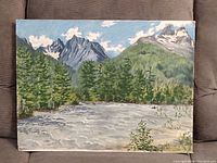 Full view of landscape painting showing mountains, trees, river, and sky.