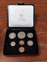 Complete set of seven 1972 Canadian coins displayed in original black case with white interior stamped with Monnaie Royale Canadienne.