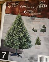 Close up of the tree packaging showing the Holiday Time brand, 6.5 foot height, Canadian pine style, 600 pre-lit lights, and fire retardant claim.