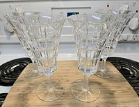 Four clear Mikasa Madison Avenue crystal glasses arranged together showing the pattern and shape clearly.