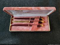 Set of 2 slimline pens and 2 letter openers in pink lined box with Bayer branding and 'Advances in Heart Disease 1994' on lid.