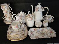 Full set displayed front view, cups stacked on left