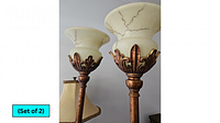Two torchiere floor lamps side by side showing alabaster shades and metal detailing
