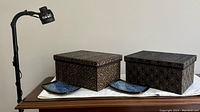Photo showing the floor lamp, two bamboo decorative boxes with lids, and two small blue ceramic trays arranged on a wooden surface.