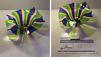 Two images of a vibrant, handblown Murano glass bowl with flared ruffled edges and colorful thin ribbon stripes in blue, red, yellow, green, and white, showing front and top views with light reflections.