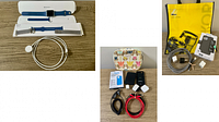 Apple Watch 38mm with blue band, additional bands, Apple magnetic charging cable, various phone cases, cables, and charging blocks displayed on wood surface
