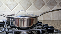 Side view of 10-inch stainless steel skillet with lid on stovetop