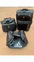 Three-piece luggage set including Travel Pro carry-on, Wenger SwissGear suitcase, and Adidas athletic bag shown together.