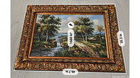 Photo showing the entire framed canvas painting depicting a landscape scene with trees and water, including dimensions displayed on the frame.