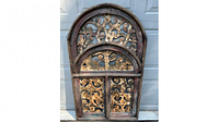 Front view of arched wrought metal and rustic wood window art piece showing intricate scrollwork and weathered wood frame.