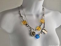 Necklaces worn on display bust showing combined design and length.