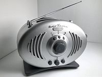 Silver oval-shaped Kenwood Radio Toaster with arched vents, central tuning dial, three control buttons, and antenna on top