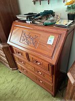 Desk closed, showing front carving and overall form