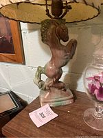 Rearing horse ceramic lamp base with scalloped fabric shade, braided trim