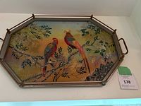 Full view of octagonal tray showing two colorful birds sitting on branches with leaves and mother of pearl inlay along one edge.