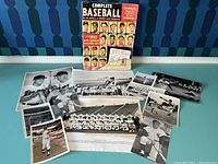 Photo of a collection including a 1952 Complete Baseball magazine and multiple black and white baseball player photos in various poses and scenes.