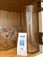 Photo showing two tall clear glass vases and one clear glass bowl with raised pink and green rose detailing.