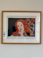 Front view of the framed wall art print depicting a stylized portrait of a woman resembling Botticelli's Birth of Venus in Andy Warhol style under glass.