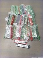 Set of 13 power distribution blocks individually packaged, plus two blocks shown outside packaging on tabletop.