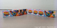 Six boxed face painting kits arranged in a row with front colorful design showing butterfly and paint splashes.