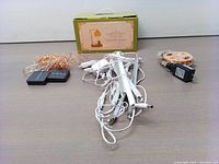 Photo showing tangled cable string lights and candle warmer lamp with its box