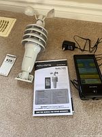 Photo showing 3-in-1 sensor, digital console, manual, and power adapter together.