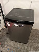 Front view of Danby Designer small refrigerator with closed door showing dark grey door and black trim and top.