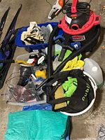 Overview of the lot showing Jobmate shop vacuum, two blue tarps, assorted rags, spray bottles, rubber gloves, and other cleaning items in blue bins.