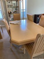 Front angle of oak whitewash double pedestal dining table with chairs