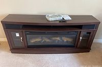 Full front view of console showing built-in insert, glass doors, open top shelf with accessories