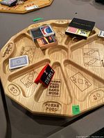 Wooden poker pool board with card decks and poker chips on top, showing carved suits and poker pool text