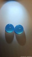 Pair of bright icey blue chalcedony round cabochon gemstones, approximately 10mm diameter each.