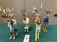 Four reindeer front view on green surface against wood backdrop