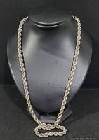 Full view of twisted rope chain draped on display bust