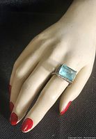 Ring worn on mannequin hand showing overall size and appearance.