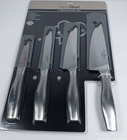 Photo of Prime Chef branded 4-piece kitchen knife set in original sealed packaging showing the four knives with black handles and protective covers over blades.