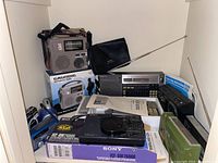 Overview of multiple portable radios and boxes on shelf