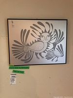 Full view of framed print on wall showing two stylized birds