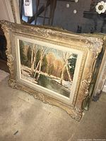 Angled view of the framed painting showing overall condition and ornate gold frame.