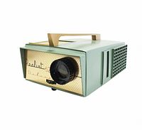 Pale mint green Realist projector with beige polka-dot front and black lens