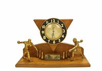 Wooden bowling trophy clock with metal bowling figurines on wood base and triangular black-bezel clock face with gold numerals