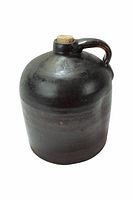 Single large dark brown jug with cork stopper