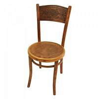 Single wooden chair showing embossed decorative patterns on backrest and round seat with curved legs.